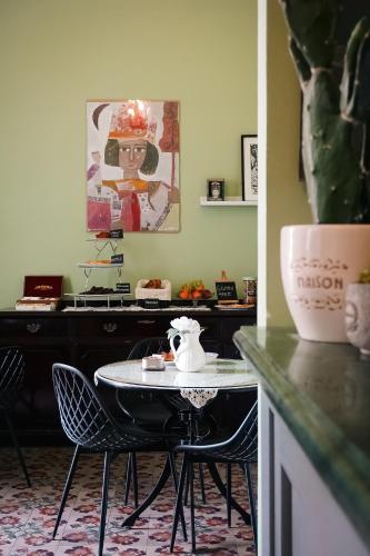 a kitchen with a table and chairs and a counter at Santuzza Art Hotel Catania in Catania