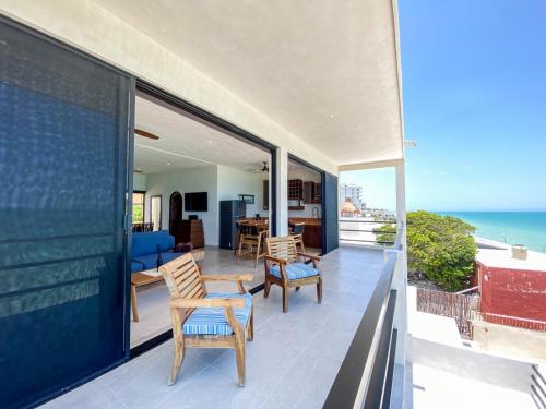 a house with a balcony with a view of the ocean at Playanet in Chelem