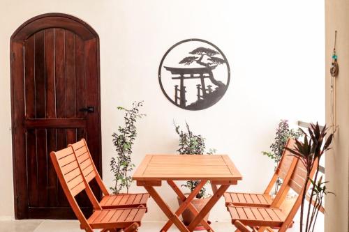 a table and two chairs with a table and a sign on the wall at Playanet in Chelem