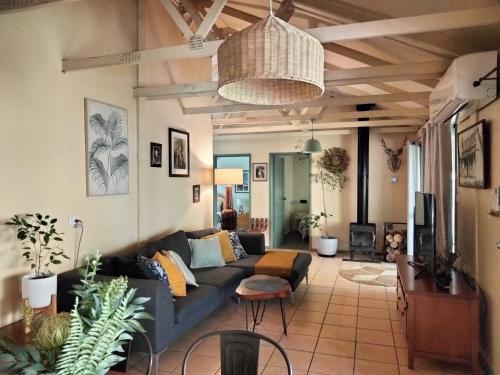 a living room with a couch and a table at Kalimna Woods Cottages in Lakes Entrance