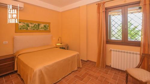 a bedroom with a bed and a window at La Casa di Farfa - Lovely Home in Sabina in Bocchignano