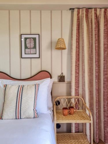 a bedroom with a bed and a table with a lamp at Nomad Boutique Resort Benidorm in Benidorm
