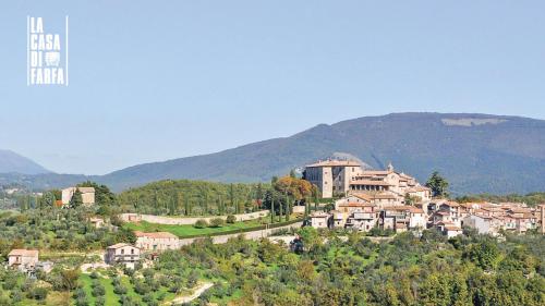 a small town on a hill with houses and trees at La Casa di Farfa - Lovely Home in Sabina in Bocchignano