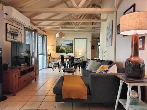 a living room with a couch and a table at Kalimna Woods Cottages in Lakes Entrance