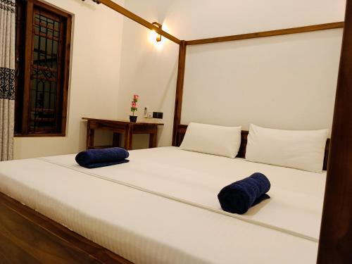 a bedroom with a bed with two pillows on it at Elite Bay Arugambay in Arugam Bay
