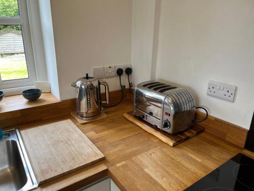 a kitchen with a toaster sitting on a counter at Maes Y Grove Cottage in Carmarthen