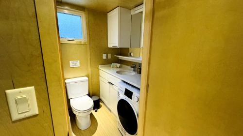 a small bathroom with a toilet and a sink at Escape Tiny Two in Chattanooga