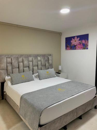 a bedroom with a large bed in a room at Hotel Santa Sofia in Bucaramanga