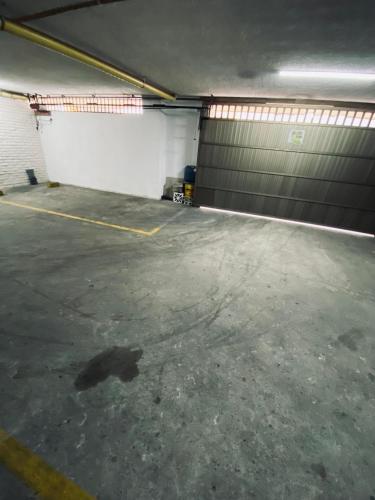 an empty garage with a garage door and a parking lot at Hotel Santa Sofia in Bucaramanga