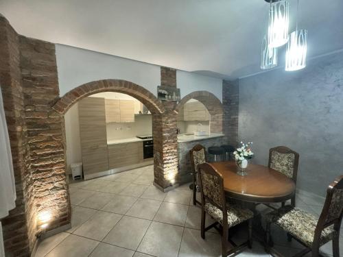 a kitchen and dining room with a wooden table and chairs at Casa Nada in Neive