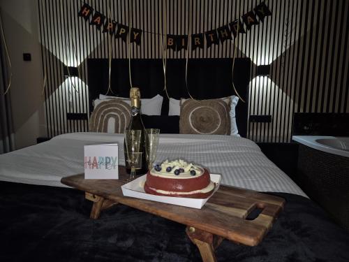 a birthday cake on a table on a bed at Hotel Broer & Zus in The Hague