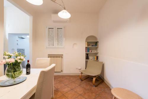 a kitchen and dining room with a table and chairs at 2 apartments next to a market and Piazza Santa Croce - HomeUnity in Florence