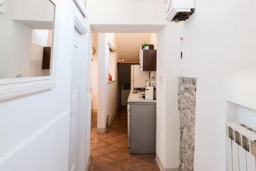 a kitchen with white walls and a counter top at 2 apartments next to a market and Piazza Santa Croce - HomeUnity in Florence