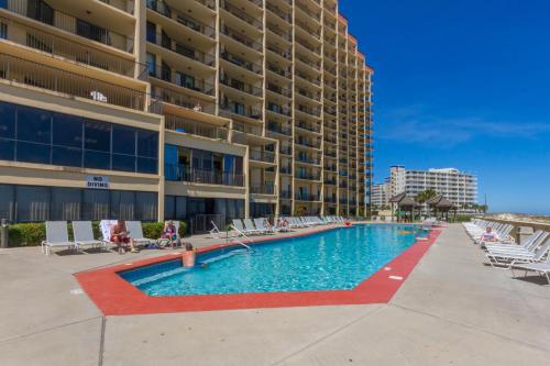 a swimming pool in front of a large building at Phoenix V 202 in Orange Beach