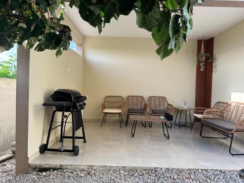 a room with chairs and a grill and a table at Casa Vista Mar in Río San Juan