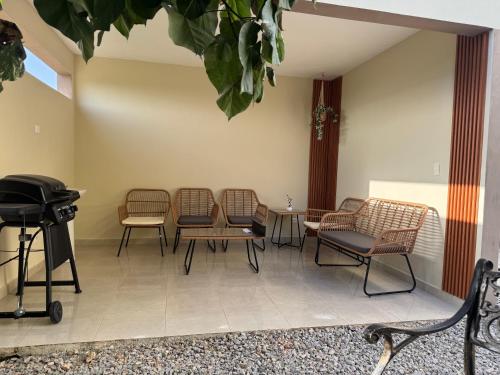 a waiting room with chairs and a table and a grill at Casa Vista Mar in Río San Juan