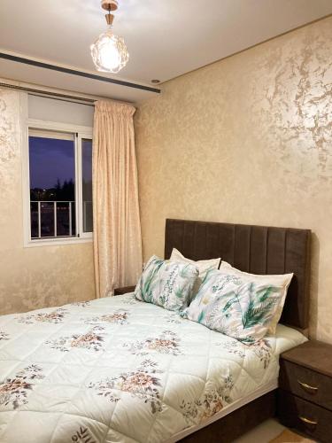 a bedroom with a bed with a window at Cozy apartment in Ifrane in Ifrane
