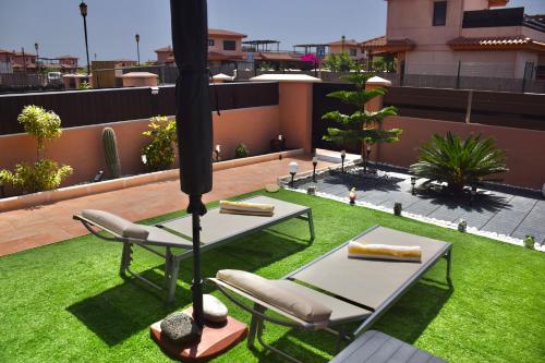 a patio with two tables and chairs on a roof at Villa Zen in Majanicho