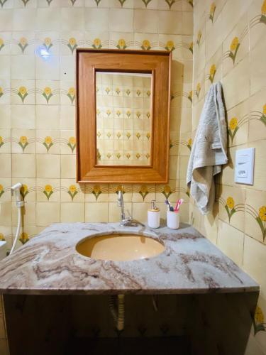 a bathroom with a sink and a mirror at Casa la Bohème in Serra