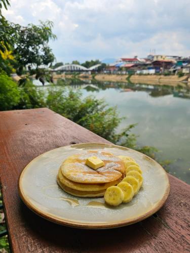 a plate of pancakes with a piece of butter on top at Kanecha's Home Lampang in Lampang