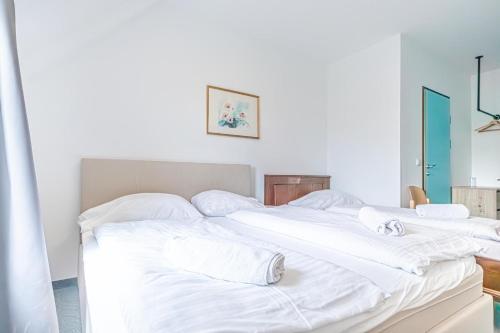 a group of white beds in a room at Hotel Astral Vienna in Vienna