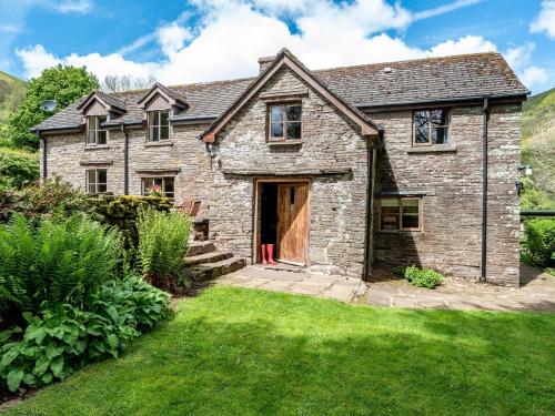 an old stone house with a grass yard at 4 Bed in Longtown 86497 in Llanveynoe