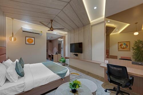 a hotel room with a bed and a tv at CLAY Royal Comfort by SOIL TO SOUL in Dwarka