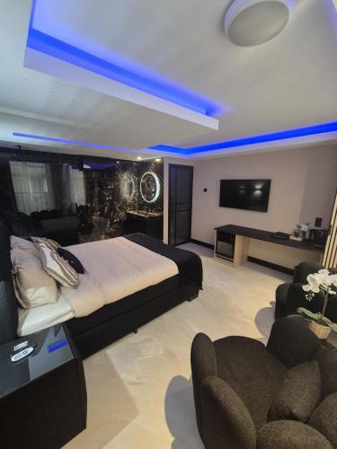 a bedroom with a bed and a couch and a tv at Hotel Broer & Zus in The Hague