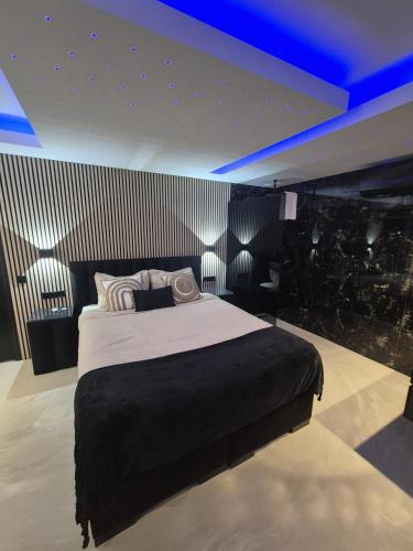 a bedroom with a large bed with blue lighting at Hotel Broer & Zus in The Hague