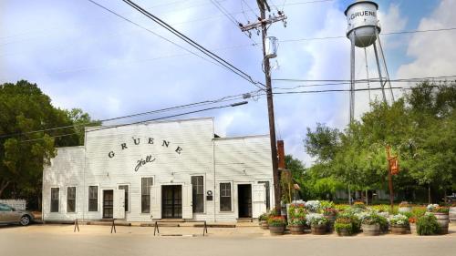 an old white building with birds on it at Holiday Inn Express & Suites New Braunfels by IHG in New Braunfels
