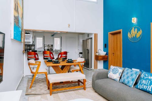 a living room with a couch and a table and chairs at Rio Minho Oasis in Dambani