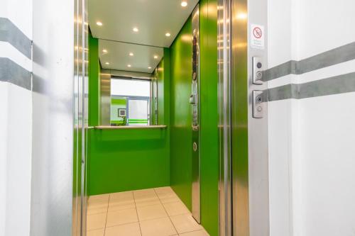 a hallway with green walls and a green door at Hotel Astral Vienna in Vienna