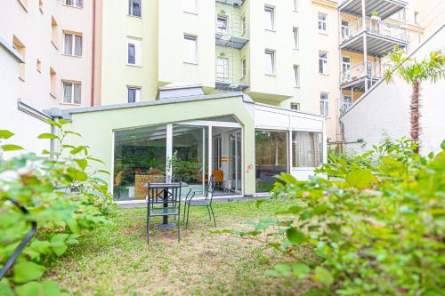 a patio with a table in front of a building at Hotel Astral Vienna in Vienna