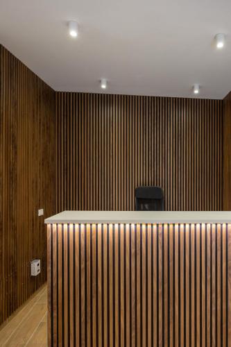 a bar in a room with wooden walls at Hotel Vicolo Aperta in Trapani