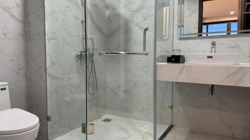 a bathroom with a shower and a toilet and a sink at Happy Ocean View Villa in Tài Xá