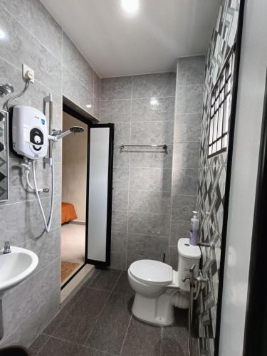 a bathroom with a toilet and a sink and a shower at SR Kampar 2-Storey LANDED HOMESTAY in Kampar