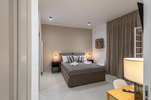a bedroom with a bed and a desk in a room at Hotel Vicolo Aperta in Trapani