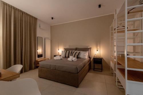 a bedroom with a bed with two pillows at Hotel Vicolo Aperta in Trapani