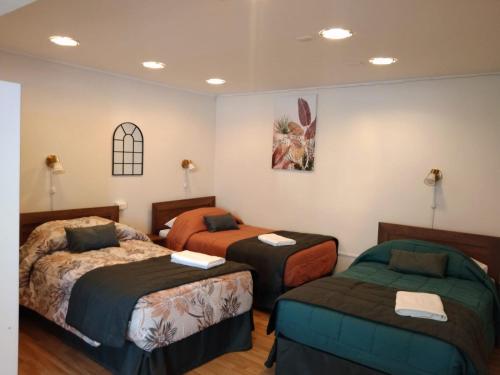 a room with three beds in a room at Ayelen Apart Hotel in Calama