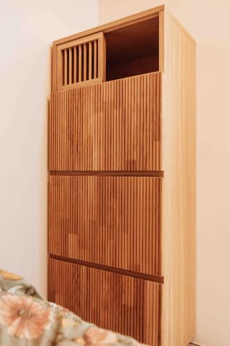 a wooden book shelf in the corner of a room at Studio Annecy in Annecy