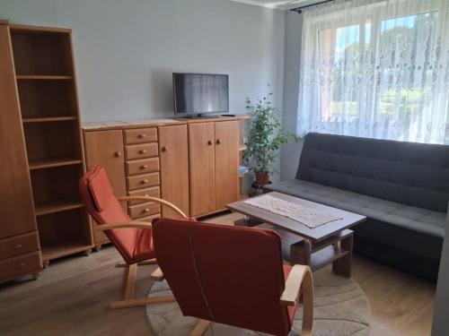 a living room with a couch and chairs and a table at Apartment, 10 min od lotniska in Miasteczko Śląskie