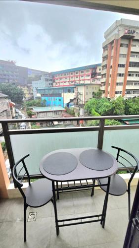 a table and two chairs on a balcony with a view at Megatower3 Baguio Condo Transient Unit 5f32 by Dei Gratia in Baguio