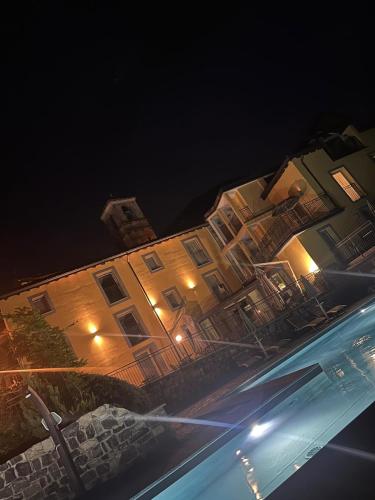 a large building at night with lights on it at Hotel Corte Santa Libera in San Fedele Intelvi