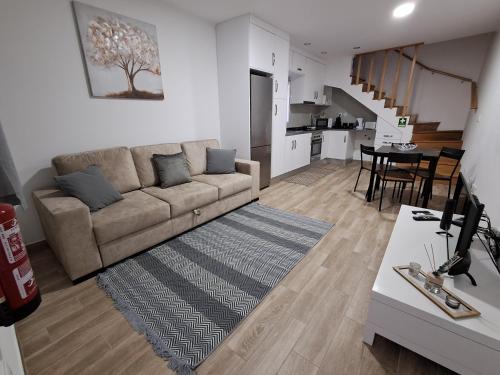 a living room with a couch and a table at Casa do Sardão in Sardoal