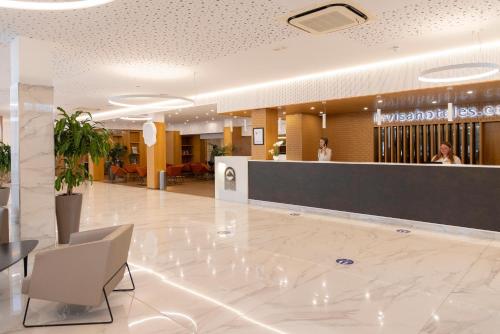 a lobby of a hospital with a reception desk at Invisa Hotel Club Cala Verde in Es Figueral Beach