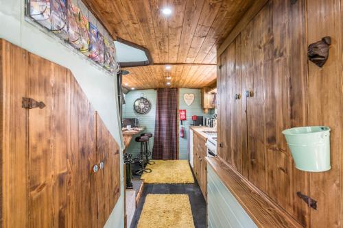 a kitchen with wooden walls and a wooden ceiling at The Bus Stop, Thornham Magna in Thornham Magna