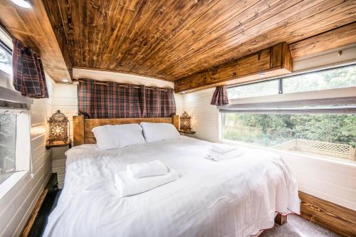 a bedroom with a large bed in a tiny house at The Bus Stop, Thornham Magna in Thornham Magna