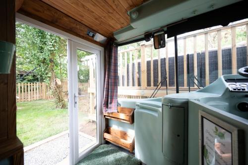 a screened in porch with a washer and dryer at The Bus Stop, Thornham Magna in Thornham Magna