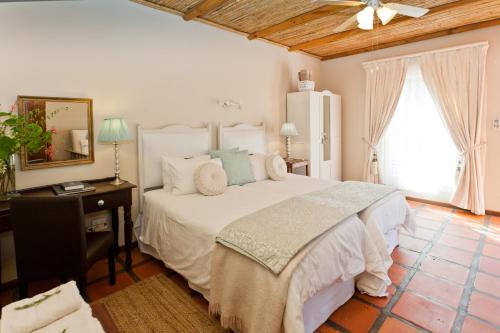Ένα ή περισσότερα κρεβάτια σε δωμάτιο στο Oue Werf Country House