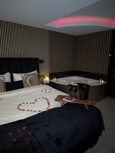 a bedroom with a bed and a bath tub at Hotel Broer & Zus in The Hague